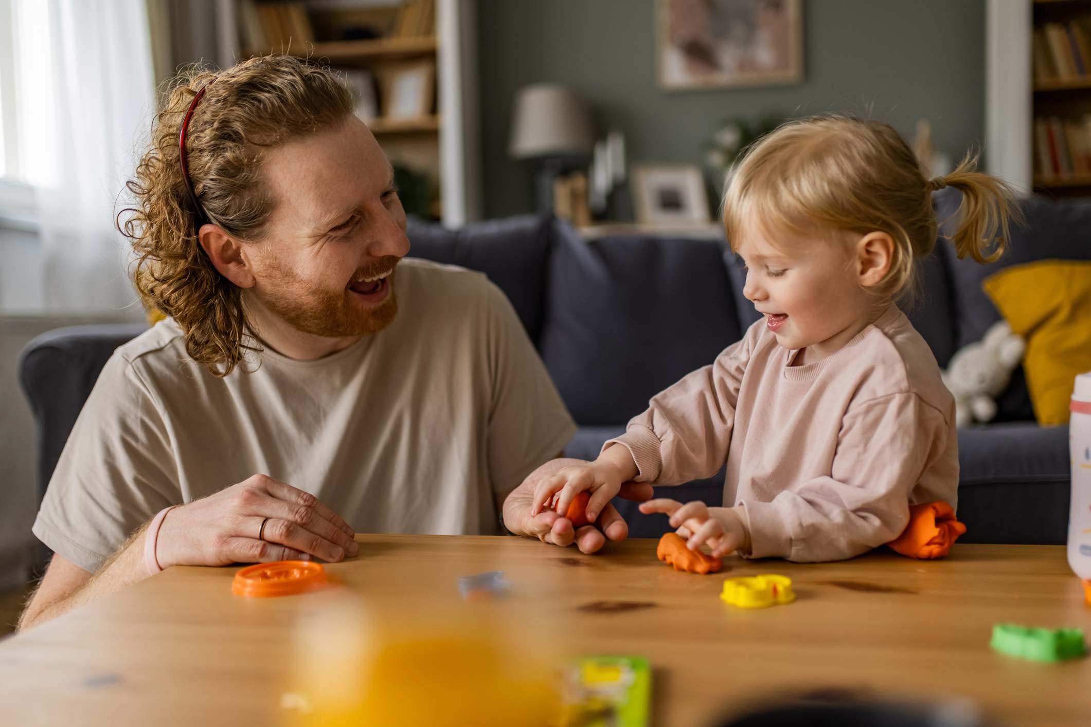 Happy father and his little daughter daughter playing and spending time together at home.